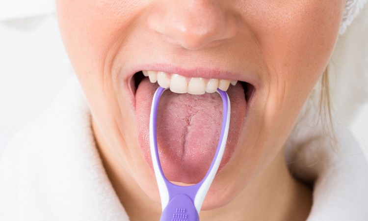 40246109 - close-up of a woman cleaning her tongue